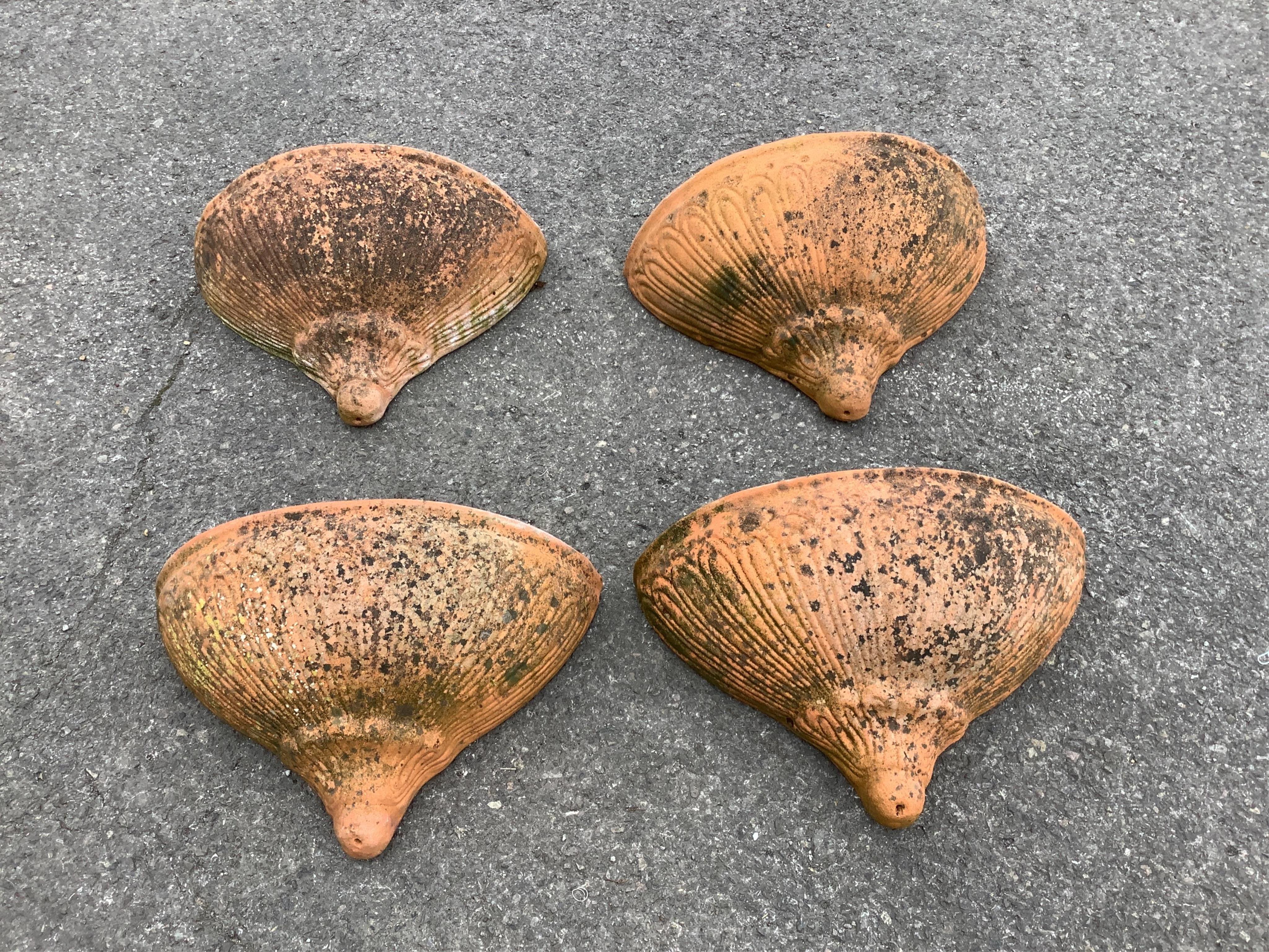 A set of four weathered terracotta wall pockets, width 44cm, depth 19cm, height 30cm. Condition - good